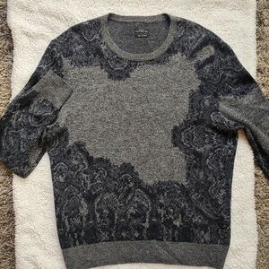 This AllSaints sweater is a long-sleeve piece in various shades of grey